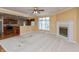 Open living room featuring a fireplace, large window, and seamless access to the kitchen at 1589 Belleflower Ct, Avon, IN 46123