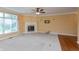 Spacious living room featuring fireplace, fan and large windows; ideal for entertaining and comfort at 1589 Belleflower Ct, Avon, IN 46123