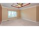 Spacious main bedroom with neutral walls, large window, and ceiling fan for a bright and airy feel at 1589 Belleflower Ct, Avon, IN 46123