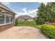 Back patio featuring a concrete slab and landscaping with a view of the expansive lawn at 1589 Belleflower Ct, Avon, IN 46123