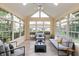 Airy sunroom with expansive windows, tiled floors, offering natural light and scenic outdoor views at 1589 Belleflower Ct, Avon, IN 46123