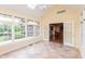 Bright sunroom filled with natural light, featuring tile flooring and multiple windows at 1589 Belleflower Ct, Avon, IN 46123