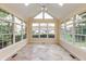 Bright sunroom with large windows and skylights, offering a view of the landscaped backyard at 1589 Belleflower Ct, Avon, IN 46123