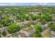 A stunning aerial view of a neighborhood with lush greenery and a city skyline in the distance at 1606 Asbury St, Indianapolis, IN 46203
