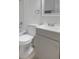 Modern bathroom with white and gray vanity, toilet, and shower/tub, complemented by chrome fixtures at 1606 Asbury St, Indianapolis, IN 46203