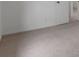 Neutral bedroom showcasing a door and neutral carpeting at 1606 Asbury St, Indianapolis, IN 46203
