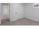 Neutral bedroom showcasing a door and neutral carpeting at 1606 Asbury St, Indianapolis, IN 46203