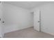 Neutral bedroom showcasing a door and neutral carpeting at 1606 Asbury St, Indianapolis, IN 46203