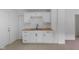 Bright kitchen featuring white cabinets, laminate countertops, and stainless steel double sink at 1606 Asbury St, Indianapolis, IN 46203