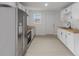 Bright kitchen features white cabinets, wood countertops and stainless steel appliances at 1606 Asbury St, Indianapolis, IN 46203
