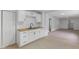 Bright kitchen featuring white cabinets, laminate countertops, and stainless steel double sink at 1606 Asbury St, Indianapolis, IN 46203