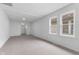 Bright room with neutral carpeting; clean, modern, and ready for personalization at 1606 Asbury St, Indianapolis, IN 46203