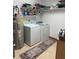 Functional laundry room with washer, dryer, and open shelving for storage at 1711 Lafayette Ave # 7, Lebanon, IN 46052