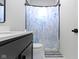 Modern bathroom features a shower with marine-themed curtain, and a dark vanity, creating a clean and stylish space at 17359 Wilkes Way, Westfield, IN 46074