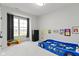 Bright bedroom features a race car bed, large window, and playful decor, creating a fun and inviting space at 17359 Wilkes Way, Westfield, IN 46074