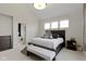 Bright bedroom with a dark wood bed frame, carpet, and ensuite bathroom at 17359 Wilkes Way, Westfield, IN 46074