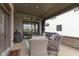 Cozy covered porch with ample seating, a grill, and seamless access to the home's interior through sliding doors at 17359 Wilkes Way, Westfield, IN 46074