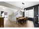 Bright dining room featuring modern light fixture, wood table, and staircase at 17359 Wilkes Way, Westfield, IN 46074