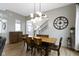 Bright dining room featuring modern light fixture, wood table, and staircase at 17359 Wilkes Way, Westfield, IN 46074
