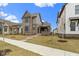 Beautiful home with a covered porch, modern siding, and professionally landscaped front yard and walkway at 17359 Wilkes Way, Westfield, IN 46074