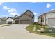 New construction home with a three-car garage and a spacious driveway at 17359 Wilkes Way, Westfield, IN 46074