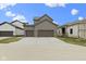 New construction home with a three-car garage and a spacious driveway at 17359 Wilkes Way, Westfield, IN 46074