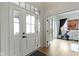 Bright foyer featuring a front door with sidelights, hardwood floors, and views into the adjacent exercise room at 17359 Wilkes Way, Westfield, IN 46074