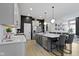 Modern kitchen features a large island with barstool seating and stainless steel appliances at 17359 Wilkes Way, Westfield, IN 46074
