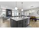 Kitchen featuring island with seating, modern fixtures, and a seamless flow to the living room at 17359 Wilkes Way, Westfield, IN 46074