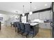Kitchen with island seating, modern lighting, stainless appliances, and view to dining room at 17359 Wilkes Way, Westfield, IN 46074