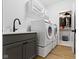 Bright laundry room with modern washer and dryer set and stylish gray cabinets at 17359 Wilkes Way, Westfield, IN 46074