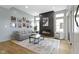 Bright living room featuring a modern fireplace, gray sofa, and neutral rug, perfect for relaxing and entertaining at 17359 Wilkes Way, Westfield, IN 46074
