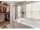 Bright bathroom with a shower, soaking tub, and walk in closet at 18278 Benton Oak Dr, Noblesville, IN 46062
