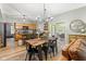 Dining area with modern chandelier, wood table, sliding glass doors to deck at 18278 Benton Oak Dr, Noblesville, IN 46062