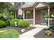 Inviting front porch with patriotic decor, landscaping and brick facade at 18278 Benton Oak Dr, Noblesville, IN 46062