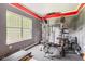Well-equipped home gym featuring a weight rack, treadmill, and large window for natural light at 18278 Benton Oak Dr, Noblesville, IN 46062