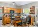 Kitchen with dark countertops, wood cabinets, and stainless steel appliances at 18278 Benton Oak Dr, Noblesville, IN 46062