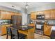 Kitchen features black appliances, granite counters, and wood cabinetry at 18278 Benton Oak Dr, Noblesville, IN 46062