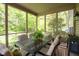 Inviting screened porch with comfortable seating and view of the lush backyard at 18278 Benton Oak Dr, Noblesville, IN 46062