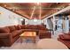 Finished basement featuring exposed wood beams, recessed lighting, and a cozy lounge area with a large sectional sofa at 2110 Allison Ave, Speedway, IN 46224