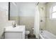 The bathroom features a shower/tub combo and a white vanity for a clean and functional space at 2110 Allison Ave, Speedway, IN 46224