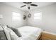 Bright bedroom with two windows, a ceiling fan, and neutral colors to create a serene and inviting atmosphere at 2110 Allison Ave, Speedway, IN 46224