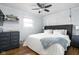 This cozy bedroom features hardwood floors, a ceiling fan, and a neutral color scheme that creates a relaxing ambiance at 2110 Allison Ave, Speedway, IN 46224
