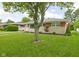 Landscaped front yard with green grass and mature tree accentuating the brick and stone exterior of the home at 2110 Allison Ave, Speedway, IN 46224