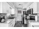 Modern kitchen with white cabinets, stainless steel appliances, and sleek countertops at 2110 Allison Ave, Speedway, IN 46224