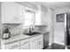 Well-maintained kitchen with white cabinets, stainless steel dishwasher and modern countertops at 2110 Allison Ave, Speedway, IN 46224