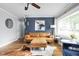Living room featuring hardwood floors, stylish decor, leather sofa, and a large window at 2110 Allison Ave, Speedway, IN 46224