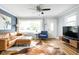 Bright and cozy living room with hardwood floors, large window and comfortable leather sofa at 2110 Allison Ave, Speedway, IN 46224
