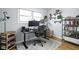This functional home office includes built-in shelving and industrial-style pipe shelving for storage and organization at 2110 Allison Ave, Speedway, IN 46224