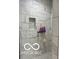 Shower featuring gray and white marble tiling, shampoo nook, and modern shower head at 217 N Liberty Blvd, Mooresville, IN 46158